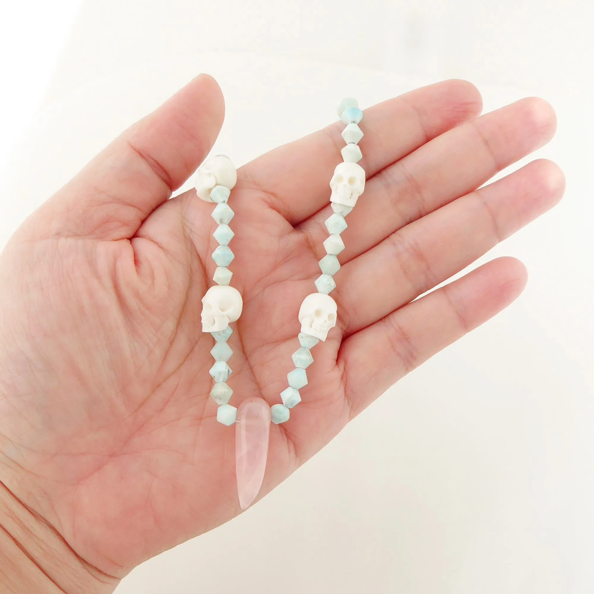 Rose quartz and carved skull necklace